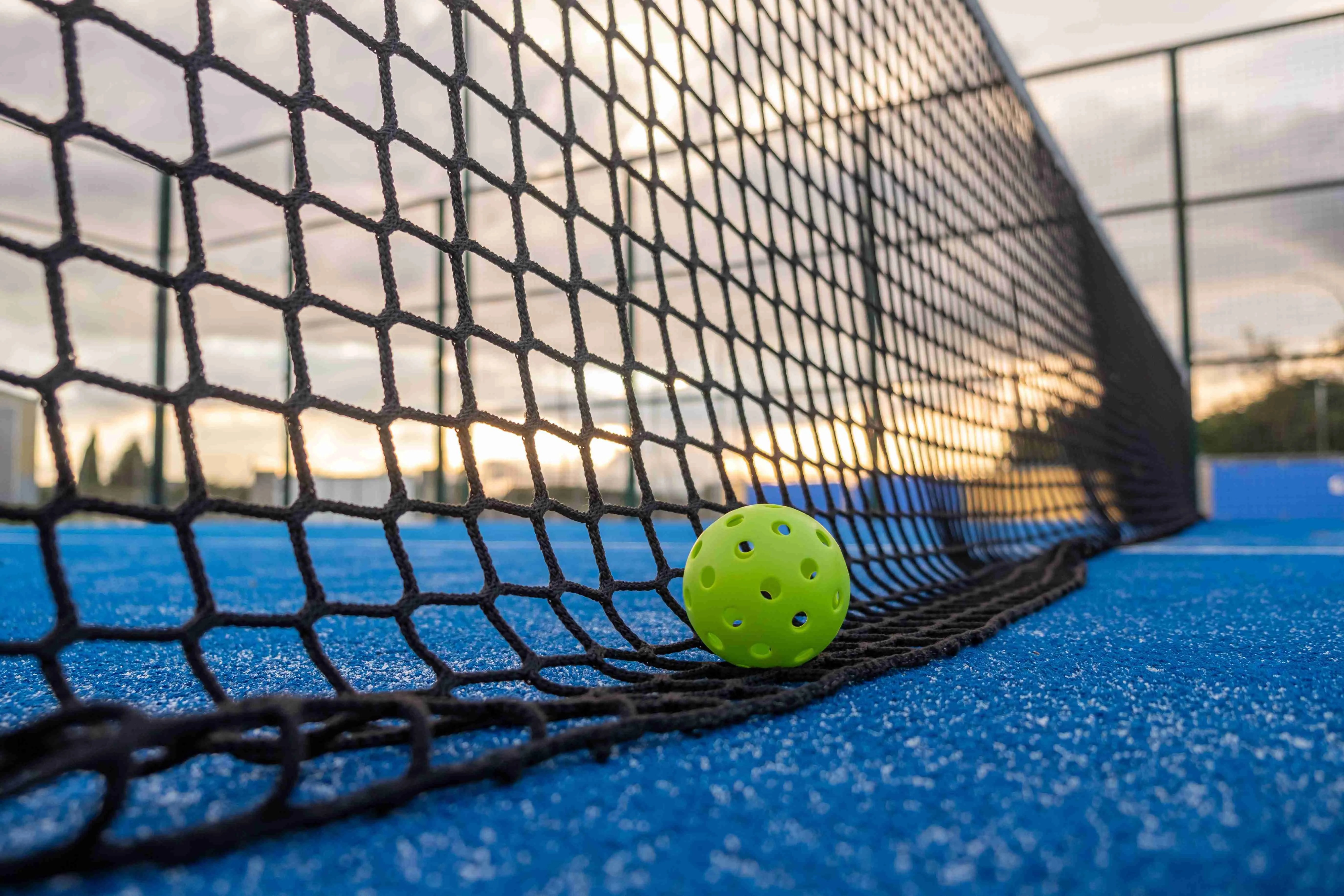 Pickleball at the net at sunset